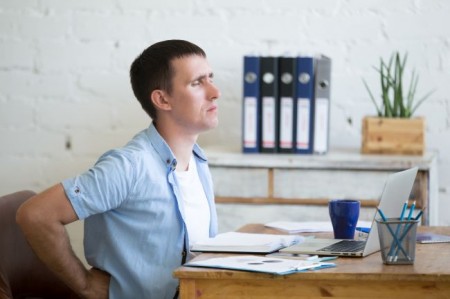 Young office man suffering from backache